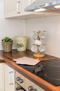 a kitchen counter with white cabinets and a sink at Sun Drop 2 with mini pool, 5-min walk to Drios beach in Drios