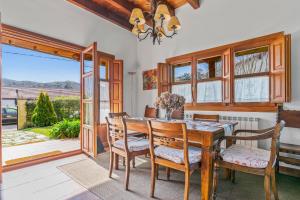 a dining room with a wooden table and chairs at Casa Mariella en Linares, Ribadesella in Linares