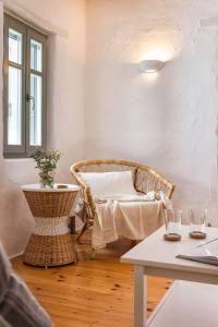 a room with a wicker chair and a table at Sun Drop 2 with mini pool, 5-min walk to Drios beach in Drios