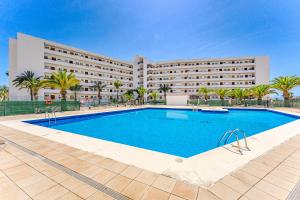 a hotel with a swimming pool in front of a building at Luz de la Luna - Ocean View - Las Americas in Costa de Adeje