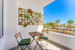 a table and chairs on a balcony with a view at Luz de la Luna - Ocean View - Las Americas in Costa de Adeje