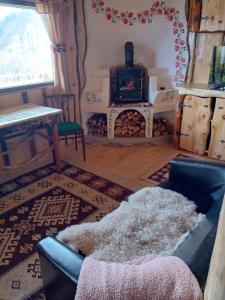 a living room with a couch and a fireplace at Casa rustica in Braşov