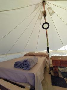 a room with a bed in a tent at Camping B&B La Contea in SantʼAnna Arresi