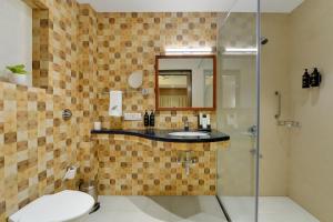 a bathroom with a sink and a shower at The Fern Residency Woodland, Pune in Pune +13 photos