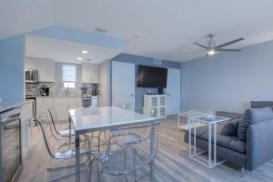 a kitchen and living room with a table and a couch at A Wave From It All Oceanview 2Nd Level Patio in Jacksonville Beach