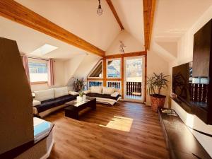 a living room with a couch and a table at Fabians Ferienhaus - Rurseeloft in Simmerath