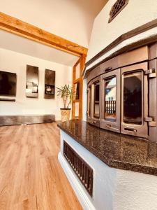 a living room with a fireplace and a tv at Fabians Ferienhaus - Rurseeloft in Simmerath