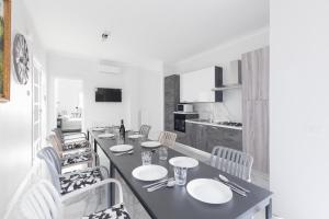 a dining room with a long table and chairs at House White Puglia by BarbarHouse in Fasano