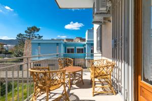 a patio with chairs and a table on a balcony at House White Puglia by BarbarHouse in Fasano
