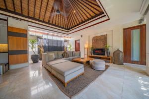 a living room with a couch and a table at Kedonganan Beach Villas in Jimbaran