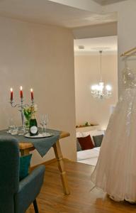 a dining room with a table with wine glasses and a dress at Schlosshotel Harburg in Harburg