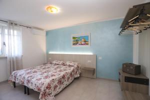 een slaapkamer met een bed en een ladekast erin bij Villa Hibiscus in Vieste +33 foto's