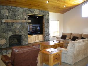 a living room with a stone fireplace and couches at Close To Everything Newly Built With Games Room in South Lake Tahoe