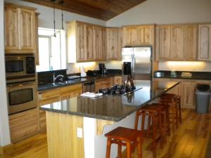 a kitchen with wooden cabinets and a granite counter top at Close To Everything Newly Built With Games Room in South Lake Tahoe