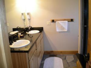 a bathroom with two sinks and a mirror at Close To Everything Newly Built With Games Room in South Lake Tahoe