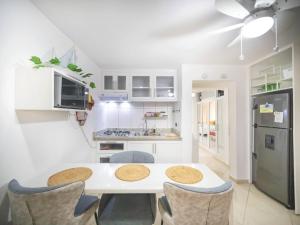 a kitchen with a table and chairs and a refrigerator at Central 1BR APT - 1 minute Walking from Rumba in Sosúa +6 photos