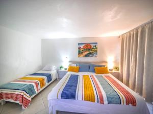 two beds in a room with two beds sidx sidx sidx sidx at Central 1BR APT - 1 minute Walking from Rumba in Sosúa