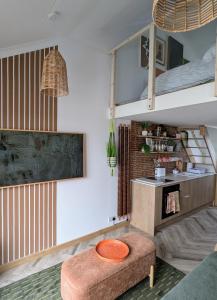 a living room with a couch and a table at TinyTin home on the ocean in Brighton & Hove +8 photos