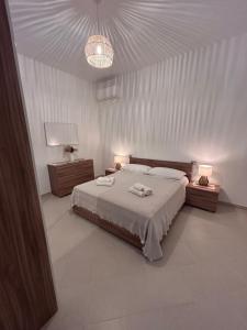 a bedroom with a bed with two towels on it at Lantana's house in Tertenìa