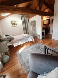 a living room with two beds and a couch at 'Quelle Belle Vue' Chambre d'Hote in Confolens