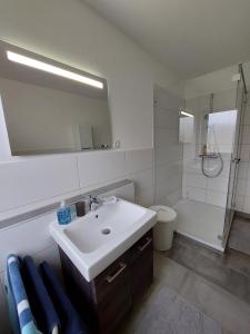 a bathroom with a sink and a toilet and a mirror at Ferienwohnung No 9 in Hameln in Hameln +13 photos