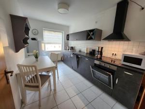 a kitchen with a table and a dining room at Ferienwohnung No 9 in Hameln in Hameln