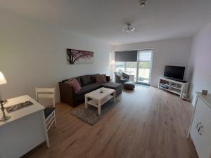 a living room with a couch and a tv at Ferienwohnung No 9 in Hameln in Hameln