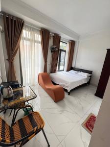 a living room with a bed and a table at NamiStay Ninh Bình - Linh Đức in Ninh Binh