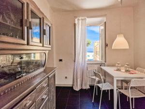 a dining room with a fish tank and a table at Apartment Piazza Mazzini Rio Marina in Rio Marina