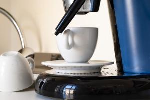 a coffee maker with a cup on a table at Apartment Piazza Mazzini Rio Marina in Rio Marina