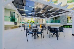 a patio with tables and chairs in a building at Qoople Legend A - Stylish accommodation by the sea in Alanya