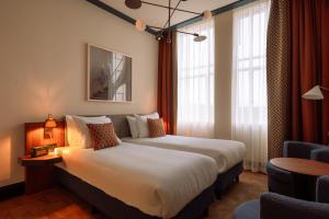 Postel nebo postele na pokoji v ubytování De Plesman Hotel The Hague