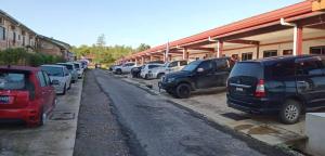 a row of parked cars parked in a parking lot at Moka Homestay Sipitang in Sipitang