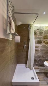 a bathroom with a shower with a toilet and a sink at La Casa del Grillo in Viterbo