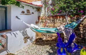 a hammock in a garden next to a building at Casa De Las Bovedas in Rosal de la Frontera +18 photos