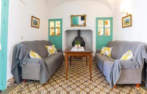 a living room with two couches and a table at Casa De Las Bovedas in Rosal de la Frontera
