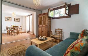 a living room with a blue couch and a table at Stunning Home In Algodonales With Wifi in Algodonales