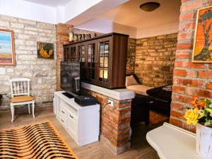 a living room with a brick wall at Hotel Taraca Gorice - UNESCO quarter in Berat