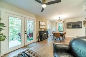 a living room with a leather couch and a dining room at Lovely Secluded Cabin Surrounded by Trees in Clarkesville, Georgia in Aerial