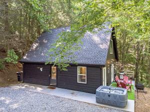a black tiny house in the woods at Lovely Secluded Cabin Surrounded by Trees in Clarkesville, Georgia in Aerial