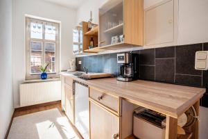 a kitchen with a wooden counter top in a room at Ferienzimmer auf Der Insel Rügen in Sagard