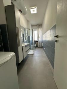 a bathroom with a sink and a toilet and a mirror at Casa Deodato in Diano Marina