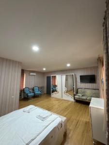 a large room with a bed and a couch at Svaneti in Lentekhi