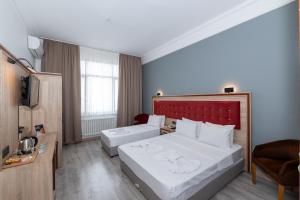 Postel nebo postele na pokoji v ubytování Olimpic Hotel
