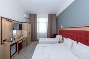 Postel nebo postele na pokoji v ubytování Olimpic Hotel