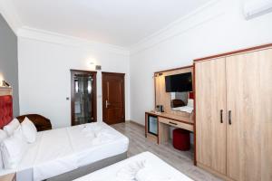 Postel nebo postele na pokoji v ubytování Olimpic Hotel