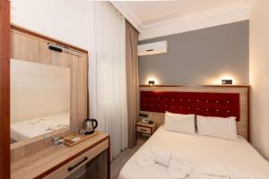Postel nebo postele na pokoji v ubytování Olimpic Hotel