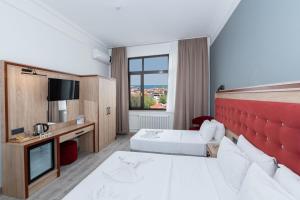 Postel nebo postele na pokoji v ubytování Olimpic Hotel