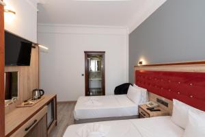 Postel nebo postele na pokoji v ubytování Olimpic Hotel