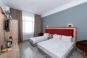 Postel nebo postele na pokoji v ubytování Olimpic Hotel